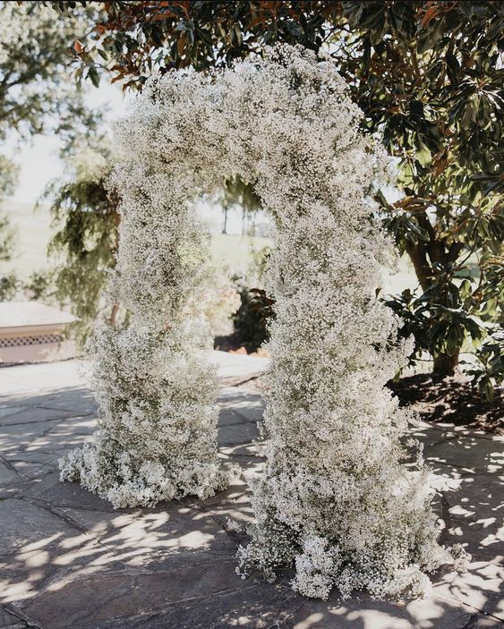 a super lush and refined white baby's breath wedding arch is a timeless and ultimately elegant solution for a wedding