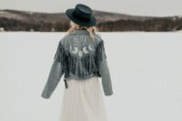 06 a blue denim bridal jacket with long fringe, calligraphy and celestial painting plus a navy hat for a winter boho bride