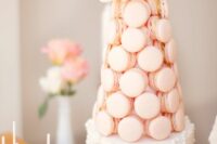 07 a refined white wedding cake decorated with edible pearls and blush macarons plus white blooms on top is very sophisticated
