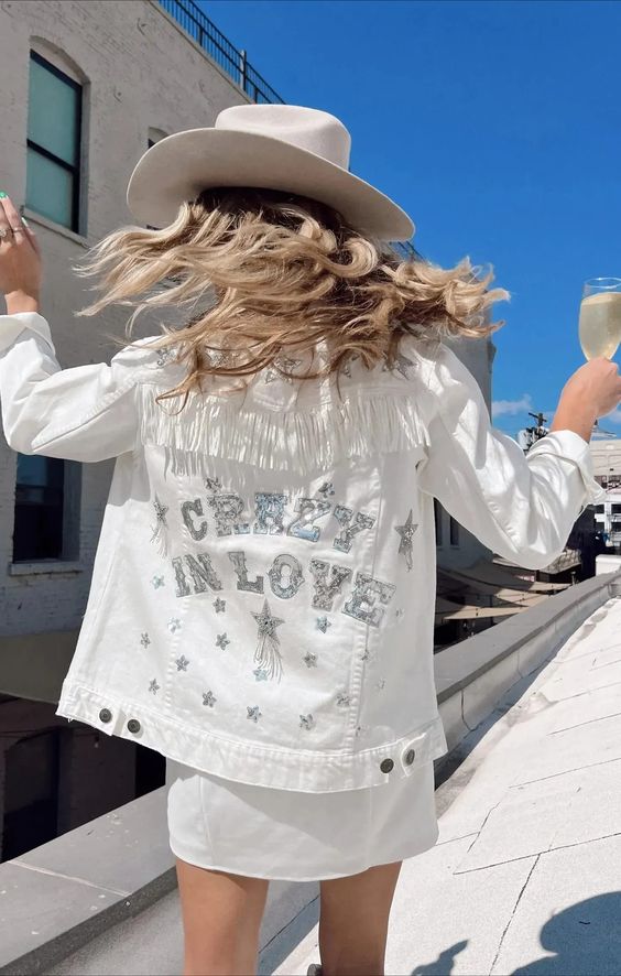a white denim jacket with fringe, silver embroidered letters and stars is a cool idea for a celestial bride