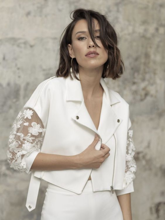 a cropped white moto jacket with lace applique sleeves is a fantastic accessory for a modern bride