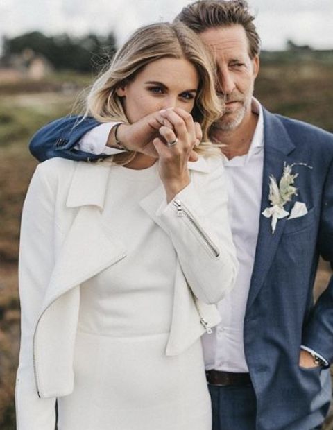 a plain minimalist wedding dress paired with a matching plain white leather jacket are a great and comfy combo for a minimalist bride