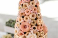 13 a whimsy pink wedding cake with gold drip and a colorful glazed donut tower, with gold foil, pink beads and greenery