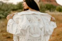 14 a white denim jacket with gold calligraphy and white fringe is a cool idea for a boho bride, add a hat and go