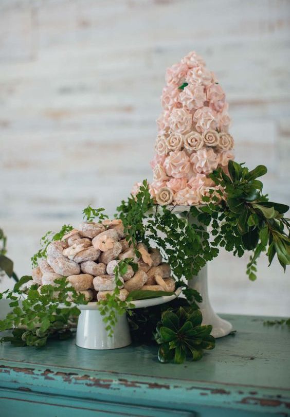 a whimsical pink meringue tower wedding cake and a stack of donuts are a great idea for a cool casual wedding