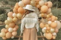 18 a neutral denim jacket with fringe and gold embroidered letters is a cool idea for a boho bride
