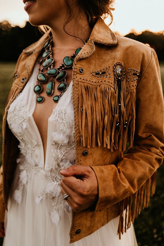 a brown leather jacket with studs and long fringe is a perfect idea for a boho or western bride, get one for your wedding