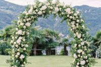 19 a chic wedding arch done with greenery and white hydrangeas is a lovely idea that will match many wedding styles