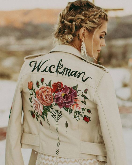 a white leather jacket with hand painted blooms and a new second name is a chic and bold cover up idea for a bride