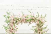 22 a lovely garden wedding arch done with greenery, blush, pink and mauve roses is a beautiful solution for a spring or summer wedding