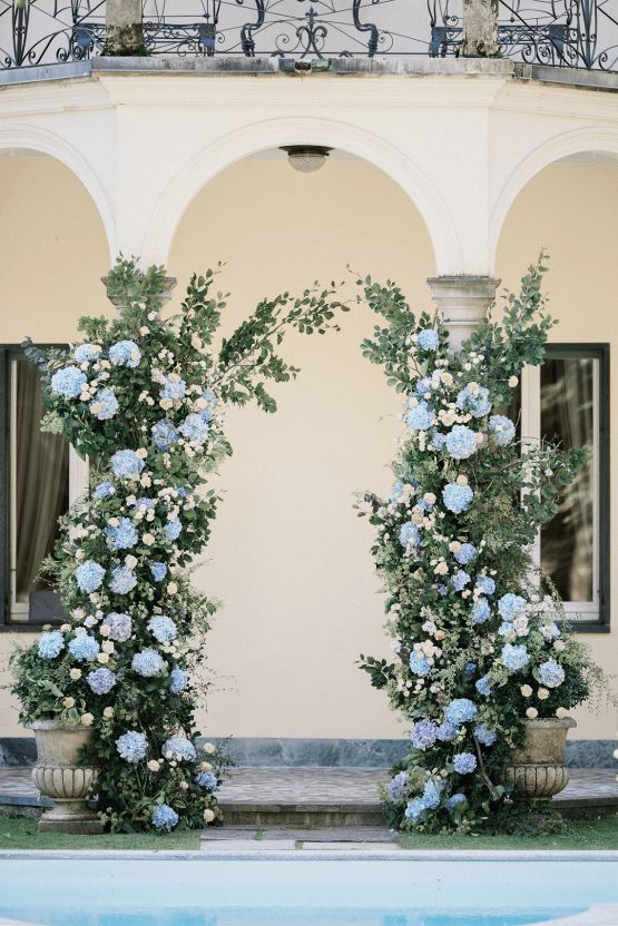 a lovely hydrangea wedding alatr created in a real wedding arch, with greenery and light blue hydrangeas is a delicate and chic idea