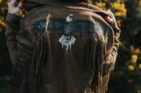 24 a brown leather jacket with fringe and a painted eagle is a great idea for a boho or western bride