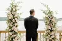 24 a pretty wedding altar with greenery and blush roses plus a lake view is a romantic idea for a spring or summer wedding
