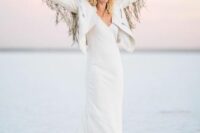 25 a boho bridal outfit with a plain white wedding dress, a creamy hat, a white jacket with fringe on the sleeves