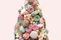 25 a quirky colorful wedding cake with chocolate drip, mint, neutral and mauve glazed donuts and macarons, candies, sugar blooms and ice cream cones
