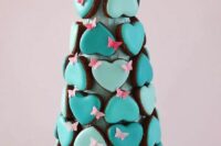 26 a quirky glazed heart-shaped cookie tower with pink sugar butterfies is a very catchy and bold idea