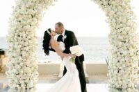 26 a white rose wedding arch is timeless classics and sophistication, it can fit a modern refined wedding