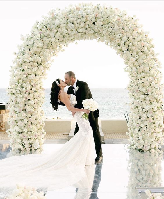 a white rose wedding arch is timeless classics and sophistication, it can fit a modern refined wedding