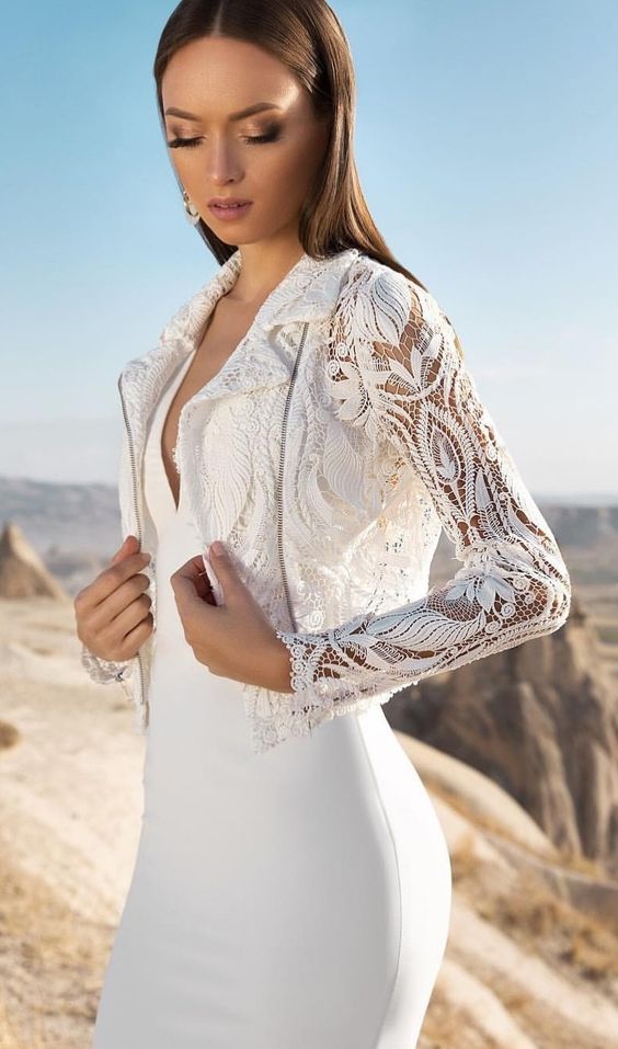 a plain plunging neckline wedding dress with a boho lace moto jacket as as an accessory than a cover up are a cool combo