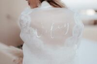 31 a sheer white bridal bomber with white calligraphy is a very chic and sophisticated idea for a modern bride