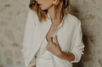 32 a simple and minimalist plain cropped bridal jacket with a zip and cropped sleeves is a chic addition to the bridal look