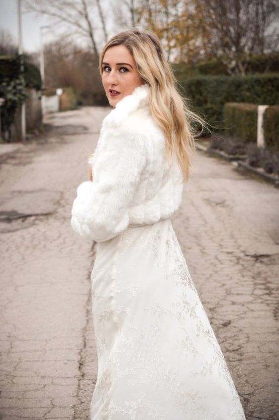 a white faux fur cropped bridal jacket is a great and timeless cover up for a modern bride