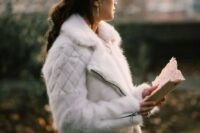 41 a white faux fur moto jacket is a unique outerwear option for a winter bride, it’s a fresh take on traditional fur coats