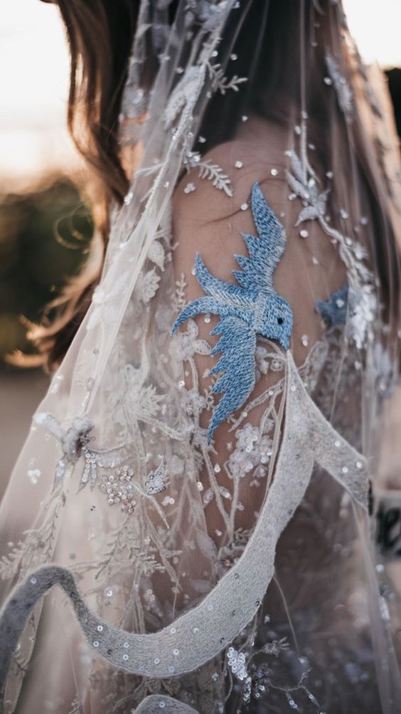 a beautiful embroidered and embellished wedding veil with crystals, sequins and blue birds is amazing for a wedding