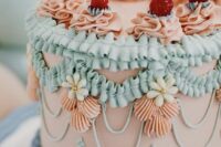 a bright and cool lambeth wedding cake in blush, aqua, light blue and topped with cherries is a fun and cool idea for a spring or summer wedding