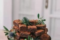 a brownie stack decorated with greenery and thistles is a gorgeous and very casual alternative to a usual wedding cake