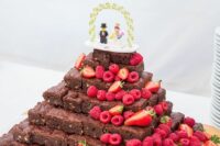 a brownie stack topped with a LEGO topper, with fresh strawberries and raspberries is a fantastic idea