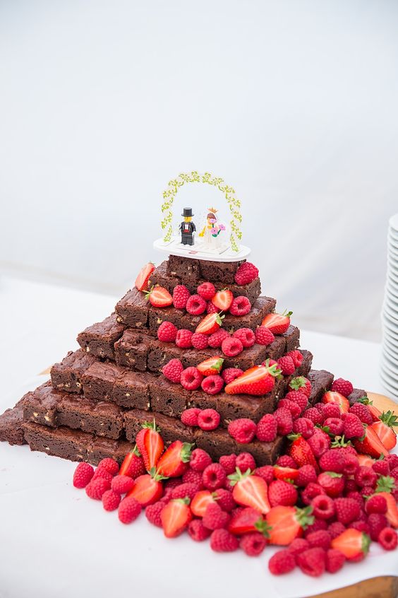 a brownie stack topped with a LEGO topper, with fresh strawberries and raspberries is a fantastic idea