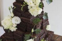 a brownie wedding cake topped with fresh white blooms and elaves is a dreamy and catchy alternative to a usual wedding cake
