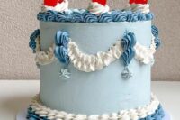 a catchy light blue, blue and white lambeth wedding cake with sugar patterns and cherries on top is amazing for summer