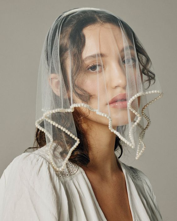 a creative mini veil with an embellished pearl edge is a fashion forward solution for a modern and edgy bride