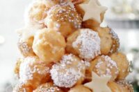 a croquembouche topped with sugar icing and caramel, edible beads and pearls and a bit of stars for a celestial wedding