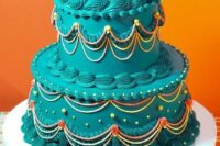 a dark green lambeth wedding cake with colorful patterns and beads is a fun and cool idea for a bold wedding