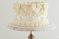 a delicate ivory lambeth wedding cake with no other details than sugar patterns is amazing for a refined neutral wedding