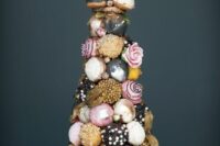 a fantastic colorful croquembouche with pink, grey, black, gold icing, edible beads, pearls and pink blooms is a glam idea