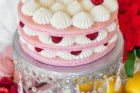 a gorgeous and delicious pink macaron cake with vanilla cream, raspberries and a pink macaron on top is amazing