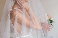 a gorgeous beaded veil worn with a beaded wedding gown adds a glam feel to the look