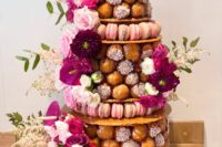 a gorgeous croquembouche with waffle tiers as stands, with pink, white and fuchsia blooms and greenery is amazing