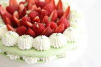 a gorgeous mint macaron wedding cake with vanilla, with fresh strawberries on top is amazing for spring or summer weddings