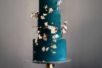 a jaw-dropping matte teal wedding cake with cherry blossom is a gorgeous idea for a spring wedding