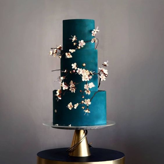 a jaw-dropping matte teal wedding cake with cherry blossom is a gorgeous idea for a spring wedding