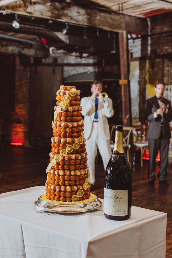 a lemon croquembouche topped with sugar icing and caramel and lemon slices is a lovely idea