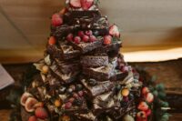 a lovely brownie stack topped with fresh berries, figs, kiwis, some greenery is a gorgeous solution for many relaxed weddings