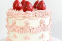 a lovely white and pink lambeth wedding cake with sugar patterns and strawberries on top is amazing