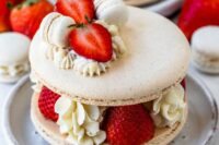 a macaron cake with vanilla cream and macarons, fresh berries inside and on top is a gorgeous idea for a wedding