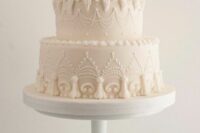 a neutral lambeth wedding cake with plenty of sugar detailing is a stylish idea for a neutral wedding with a touch of retro